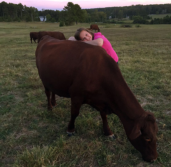 DeAnne and a Red Devon Cow